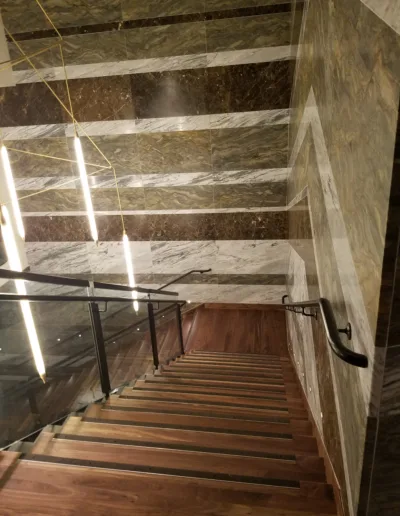 A staircase in a building with marble flooring.