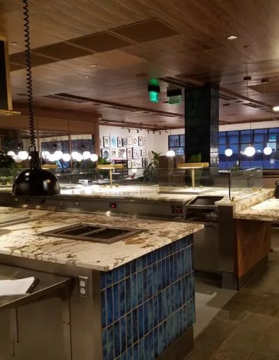 A kitchen in a restaurant with a lot of counter space.
