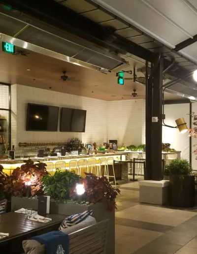 A restaurant with tables and chairs and a tv.