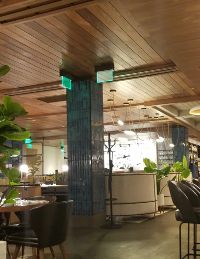 The inside of a restaurant with a wooden ceiling.