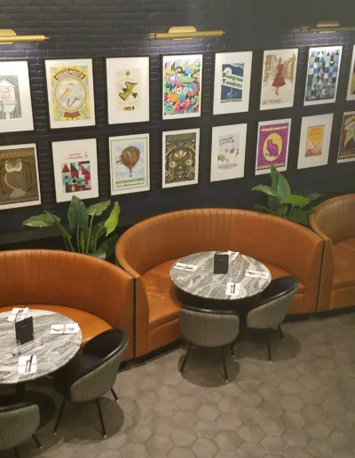 The interior of a restaurant with a lot of pictures on the walls.