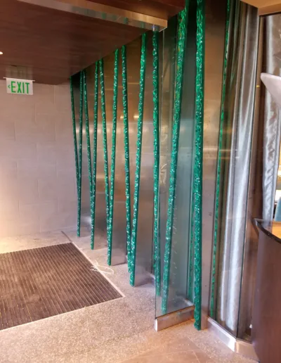 The entrance to a lobby with green bamboo sticks.