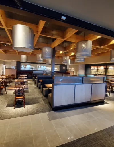 The inside of a restaurant with tables and chairs.