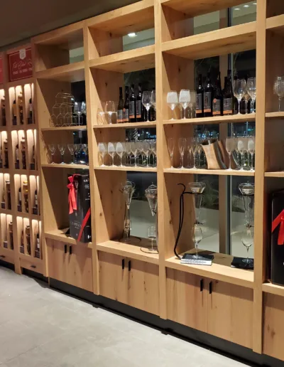 A display of wine glasses and bottles in a store.