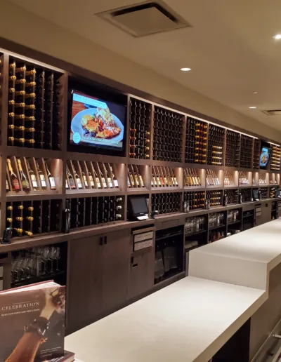 A wine bar with many bottles of wine.