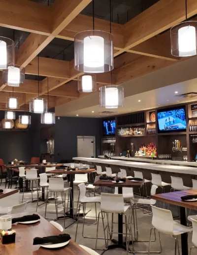 The interior of a restaurant with wooden tables and chairs.
