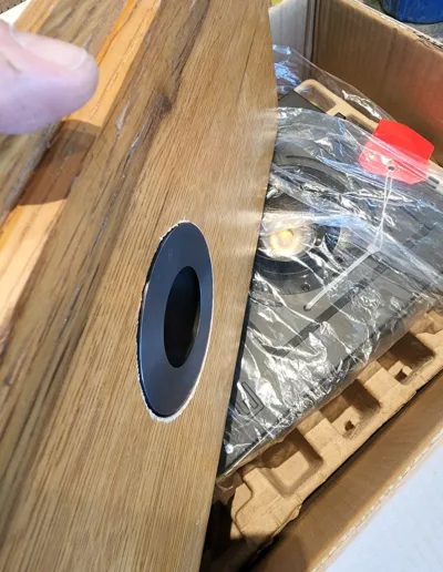 A person opening a box with a speaker in it.