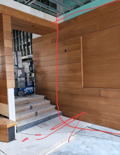 The interior of a building with wooden walls and a staircase.