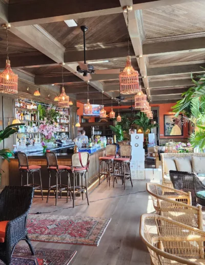 The interior of a restaurant with a tropical theme.