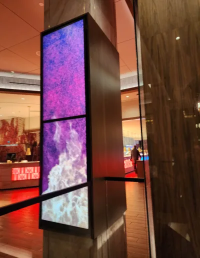 A large screen is displayed in the lobby of a hotel.