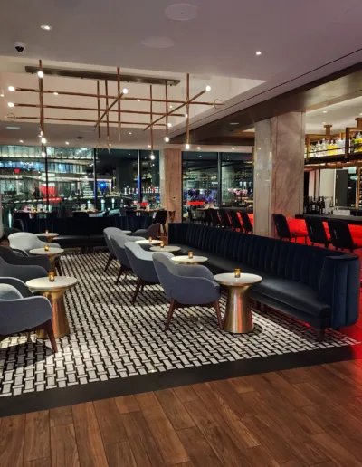 The bar area of a restaurant with a wooden floor.