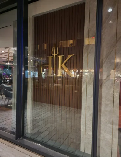 A glass door with the word hk on it.