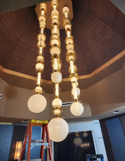 A chandelier is being installed in a room.
