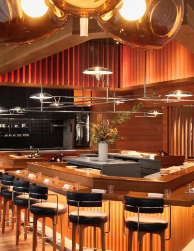 The interior of a restaurant with wooden tables and chairs.